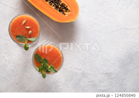 Asian popular freshness Papaya lassi , smoothie made of water, spices and ice. Traditional ayurvedic beverage in India and Sri Lanka. Close up. View from above. 124850840