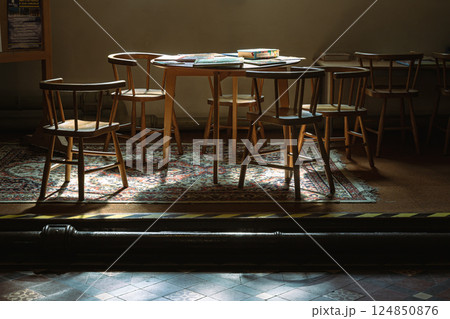 Sunbeam rays filtered through in to the Wooden tables and chairs. Sunbeam rays filtered through in to the Wooden tables and chairs. 124850876