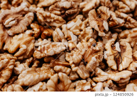 Peeled walnuts. Walnut close-up. Heap of brown fresh healthy nuts. 124850926