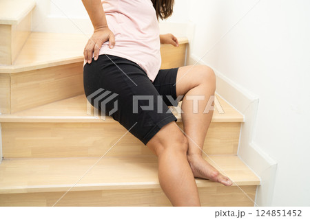 Asian lady fall down the stairs and pain at hip and waist because slippery surfaces. Asian lady fall down the stairs and pain at hip and waist because slippery surfaces. 124851452