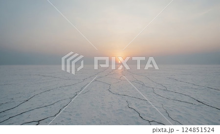 Dramatic Sunset Over Salt Desert with Cracked Landscape 124851524