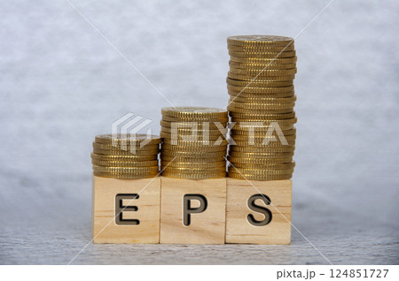 Earnings Per Share text on wooden cubes with stacking golden coins. EPS and investment concept 124851727