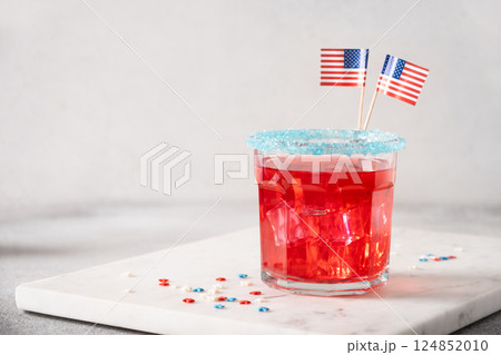 Patriotic red pomegranate margarita cocktail on white background. Rim your festive beverages in blue sugar for popping for July 4th. Close up. Copy space. 124852010
