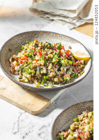 Buckwheat tabbouleh salad. Traditional middle eastern or arab dish. Levantine vegetarian salad. Buckwheat tabbouleh salad. Traditional middle eastern or arab dish. Levantine vegetarian salad. 124852053