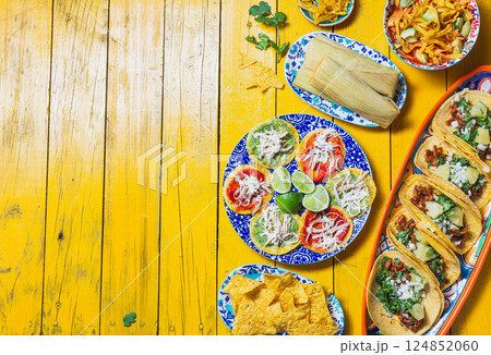 Colorful Mexican food spread featuring chalupas, tortilla soup, and traditional dishes for celebration with copy space 124852060