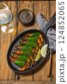 Delicious shrimp with a glass of white wine at a rustic dining table 124852065