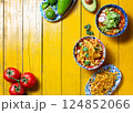 Delicious selection of traditional Mexican dishes showcasing fried tortilla, Aztec soup, and fresh ingredients for a festive celebration 124852066