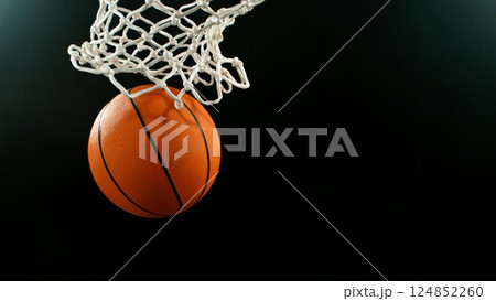 Detail of basketball ball hitting the hoop, top view. Isolated on black background. 124852260