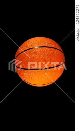 Detail of basketball ball, top view. Isolated on black background. 124852273