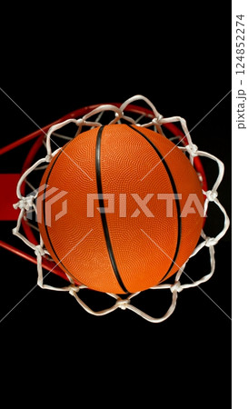 Detail of basketball ball hitting the basket, top view. Isolated on black background. 124852274