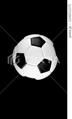 Detail of soccer ball, top view. Isolated on black background. 124852275