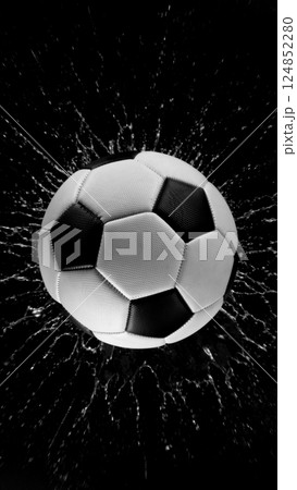 Detail of soccer ball with splashing water. Isolated on black background. 124852280