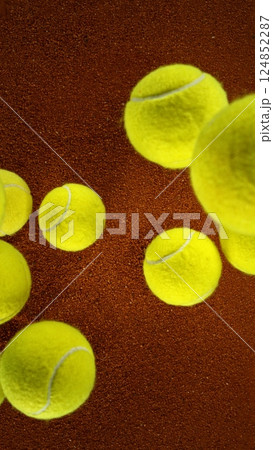 Tennis balls falling on clay surface. 124852287