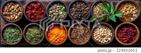 Colorful spices arranged in small wooden bowls, creating a vibrant and textured pattern. Perfect for cooking, spice markets, or food blogs. 124852651