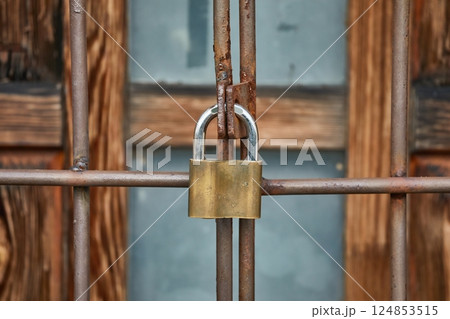 Padlock fixed on a metal fence 124853515