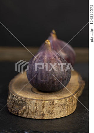fig on a wooden table, sweet fig fruits are used to make desserts, side view 124853573