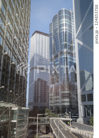 Modern skyscrapers reflect city skyline in bright daylight Modern skyscrapers reflect city skyline in bright daylight 124853788