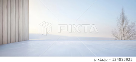 Snowy landscape with minimalist architecture and bare tree under clear winter sky 124853923