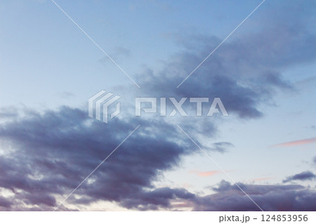 cumulus clouds on the sky at twilight. meteorology forecast. beautiful nature background in colorful light at sunset. windy winter conditions 124853956