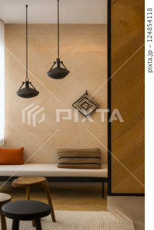 Modern minimalist interior design featuring simple furniture and warm lighting in a cozy space Modern minimalist interior design featuring simple furniture and warm lighting in a cozy space 124854118