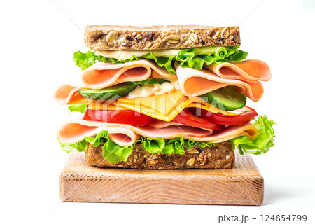 Layered sandwich with ham, cheese and vegetables on white Layered sandwich with ham, cheese and vegetables on white 124854799