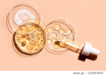 Various retinol cosmetic serum swatches in petri dish 124854845