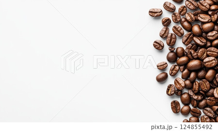 Roasted coffee beans are scattered on a white background, creating a visually appealing border with copy space, ideal for coffee related designs or advertisements 124855492