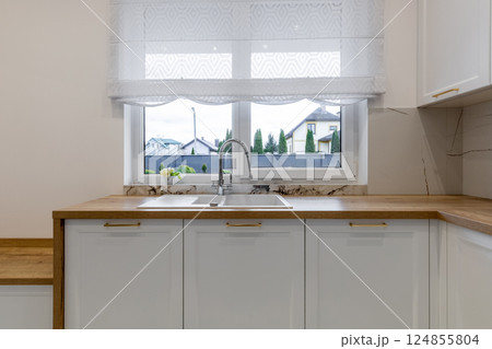 Modern Kitchen Sink with Window View Modern Kitchen Sink with Window View 124855804
