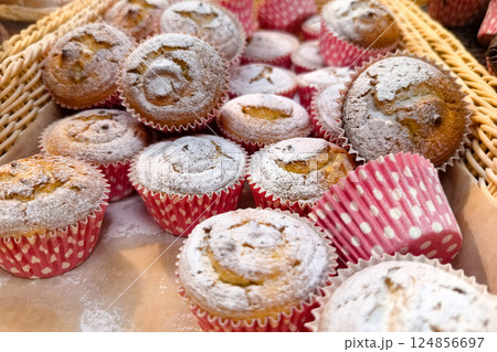 Sweet treats in vibrant paper cups enhance the festive bakery delights Sweet treats in vibrant paper cups enhance the festive bakery delights 124856697