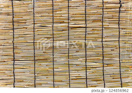 Woven bamboo decorative mat as a creative backdrop Woven bamboo decorative mat as a creative backdrop 124856962