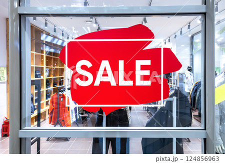 Sale sign on blurred background at a clothes store Sale sign on blurred background at a clothes store 124856963