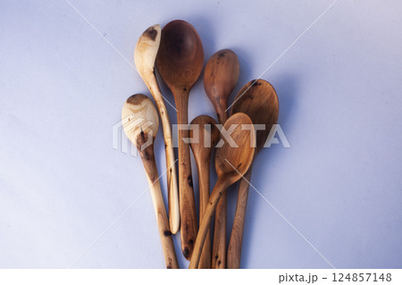 Wooden kitchen utensils stacked view isolated Wooden kitchen utensils stacked view isolated 124857148