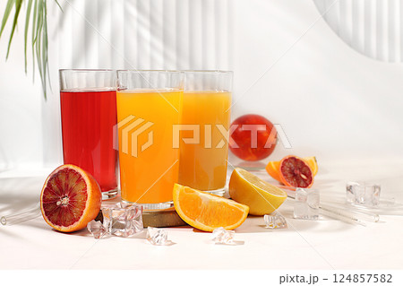 Modern still life with citrus fruits. Orange juice, thick smoothie and oranges, grapefruit, lime, blood orange and lemon on elegant kitchen table. Detox diet and weight loss concept, summer drinks, 124857582