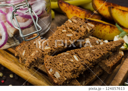 Herring with onions in a glass jar with potatoes Herring with onions in a glass jar with potatoes 124857613