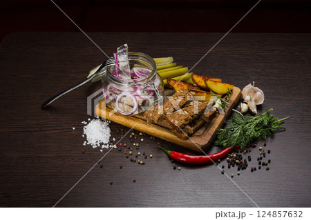 Herring with onions in a glass jar with potatoes 124857632