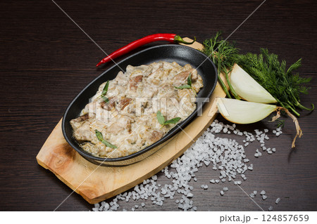 Meat in a creamy sauce with mushrooms and cheese Meat in a creamy sauce with mushrooms and cheese 124857659