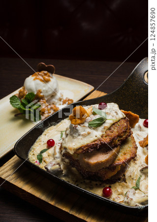 Draniki with chanterelle mushrooms, cream sauce 124857690