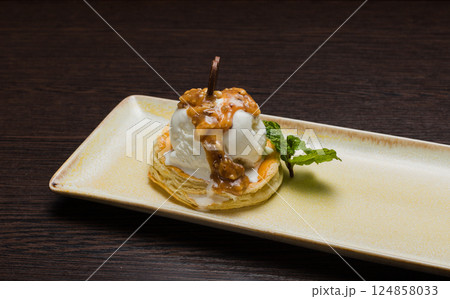 Dessert with puff pastry and ice cream drizzled Dessert with puff pastry and ice cream drizzled 124858033