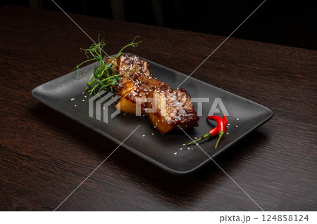 Stewed meat with sesame on a black plate, Japanese Stewed meat with sesame on a black plate, Japanese 124858124