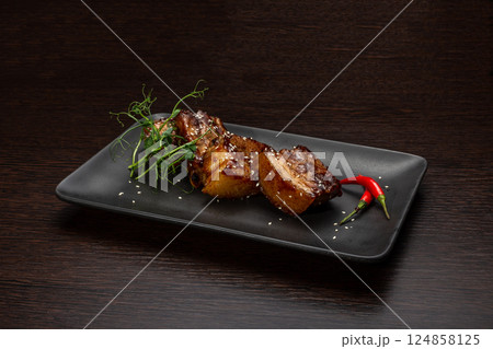 Stewed meat with sesame on a black plate, Japanese Stewed meat with sesame on a black plate, Japanese 124858125