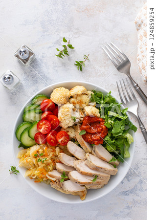 Healthy lunch bowl with grilled chicken, roasted cauliflower and fresh vegetables Healthy lunch bowl with grilled chicken, roasted cauliflower and fresh vegetables 124859254