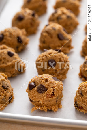 Chocolate chip cookies with pecan nuts, cookie dough ready on a baking sheet Chocolate chip cookies with pecan nuts, cookie dough ready on a baking sheet 124859268