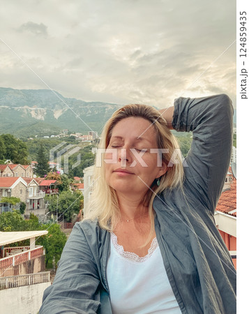 Middle aged woman enjoying stunning mountain view 124859435