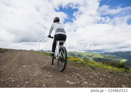 Riding mountain bike on grassland mountain top 124862522