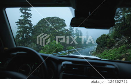 Driving offroad car on high elevation forest mountains Driving offroad car on high elevation forest mountains 124862731
