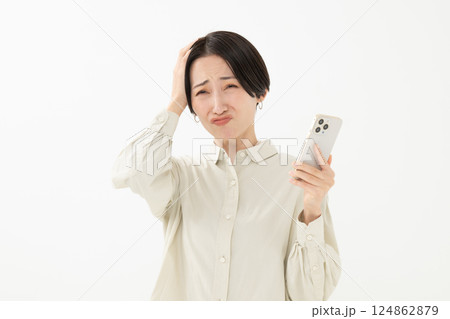スマホの画面を見て驚く女性 124862879
