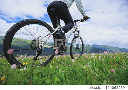 Riding mountain bike on grassland mountain top 124862989