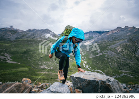 Hiking woman on high altitude mountain top Hiking woman on high altitude mountain top 124862996