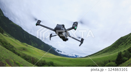 Drone flying on high altitude mountain top Drone flying on high altitude mountain top 124863101