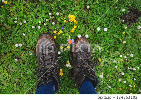 Hiker legs walking on beautiful flowering grassland 124863102
